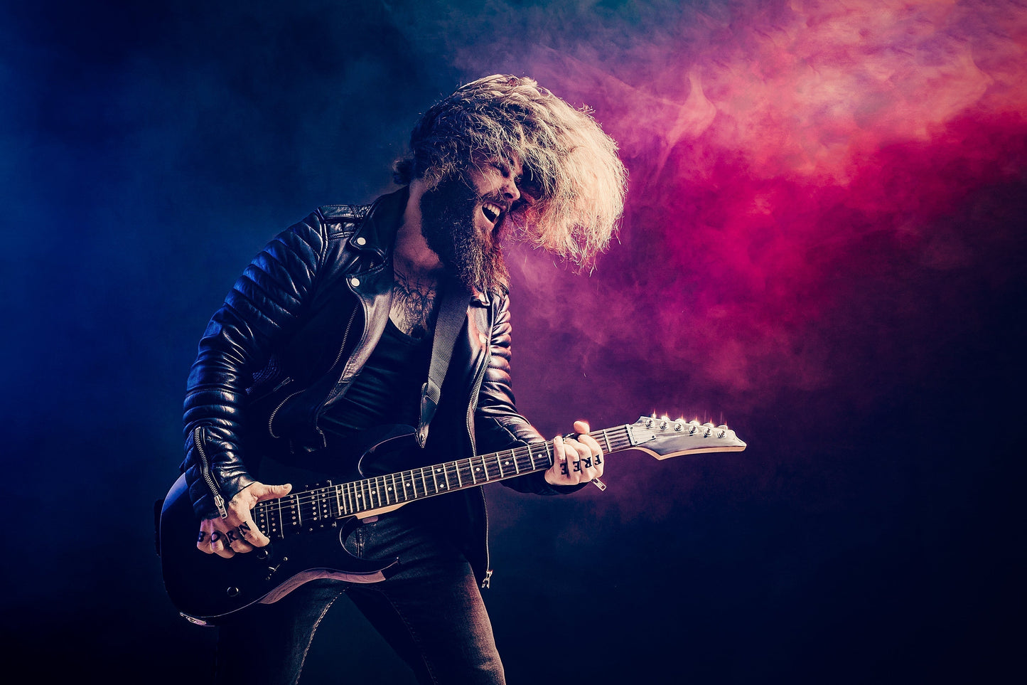 Long hair guy rocking out on a guitar