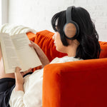 Load image into Gallery viewer, Person reading while wearing thinksound ov202w wireless over-ear headphones
