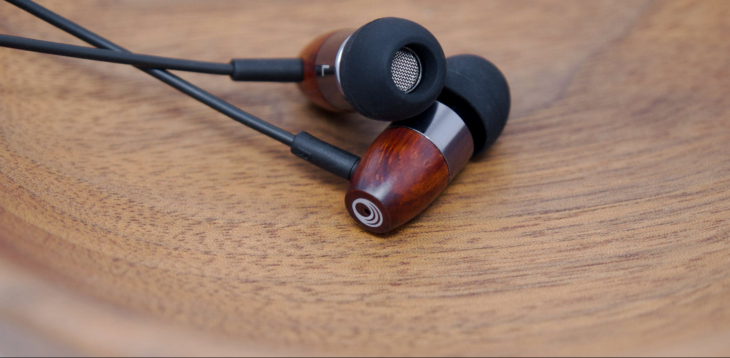 thinksound in20 wooden earbuds on a wood surface